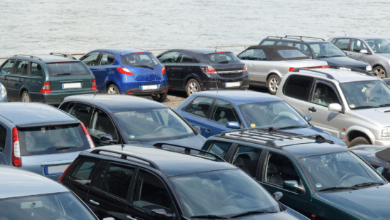 cars lined up near ocean