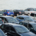 cars lined up near ocean