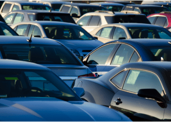cars in lot with sunrise in back