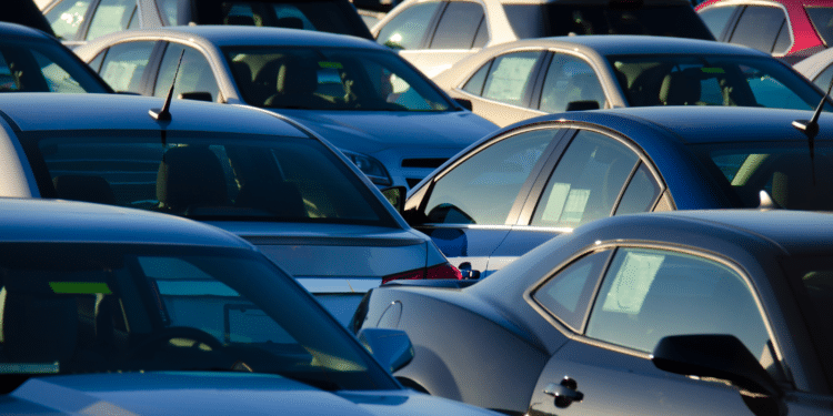 cars in lot with sunrise in back