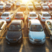 cars lined up on lot at sunset