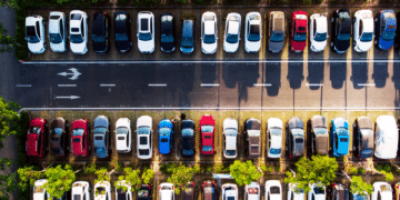 Overhead shots are cars parked along a road