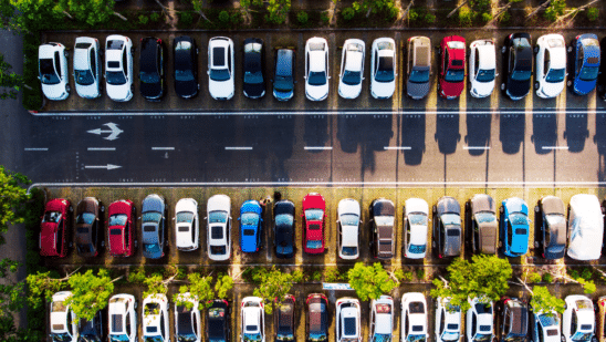 Overhead shots are cars parked along a road
