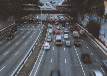 Cars on road under bridge