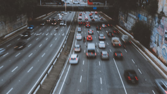 Cars on road under bridge