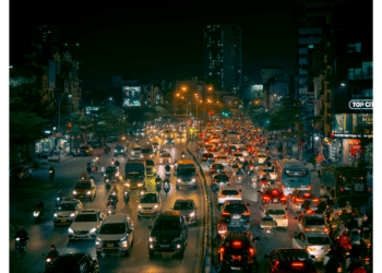 cars on road at night with lights on