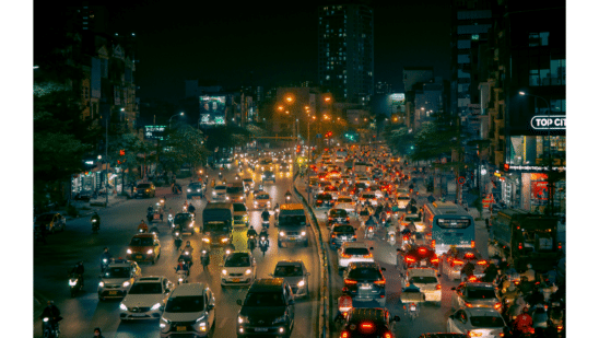 cars on road at night with lights on