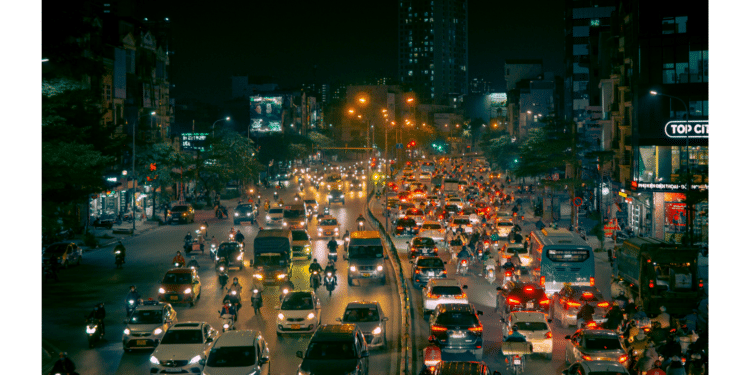 cars on road at night with lights on