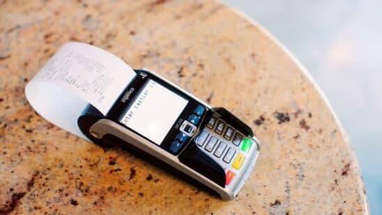 A receipt sits in a payment terminal