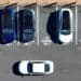 In an aerial view, Tesla cars recharge at a Tesla charger station