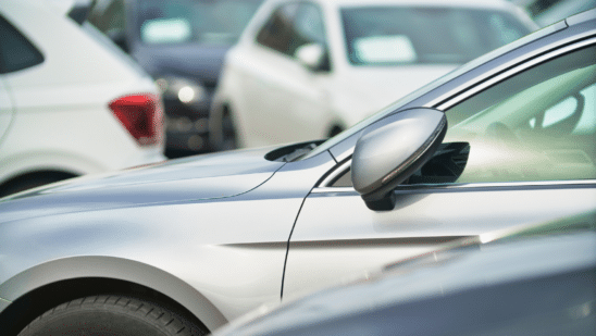 Side view of a silver car in a lot