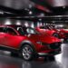 A Mazda Motor Corp. CX-30 crossover sport utility vehicle (SUV), left, displayed at the company's museum in Fuchu Town, Hiroshima Prefecture, Japan, on Wednesday, June 15, 2022. To ease the impact of inflation, Prime Minister Fumio Kishida put together a series of relief measures including bigger gasoline subsidies. Photographer: Kiyoshi Ota/Bloomberg