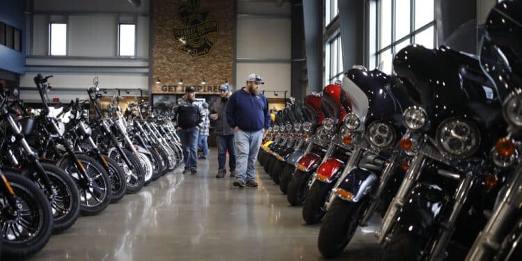 Customers walk past motorcycles at the Bluegrass Harley-Davidson dealership in Louisville, Kentucky, U.S., on Wednesday, Feb. 9, 2022. Harley-Davidson Inc. gained after reporting a surprise profit in the fourth quarter as strong demand in its home market and higher motorcycle prices padded earnings and shipping delays eased.
