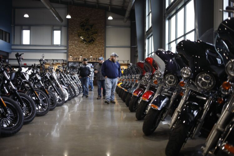 Customers walk past motorcycles at the Bluegrass Harley-Davidson dealership in Louisville, Kentucky, U.S., on Wednesday, Feb. 9, 2022. Harley-Davidson Inc. gained after reporting a surprise profit in the fourth quarter as strong demand in its home market and higher motorcycle prices padded earnings and shipping delays eased.