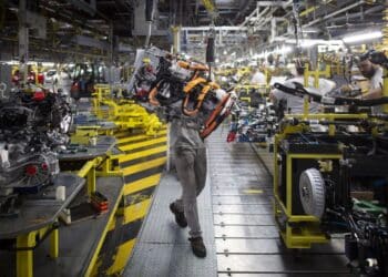 An employee uses a winch to mount the drive train system of a Renault Twingo Electric at the Renault Revoz d.d. plant in Novo Mesto, Slovenia. Photographer: Oliver Bunic/Bloomberg