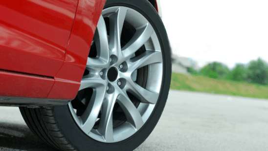 Closeup of a car tire on a red vehicle