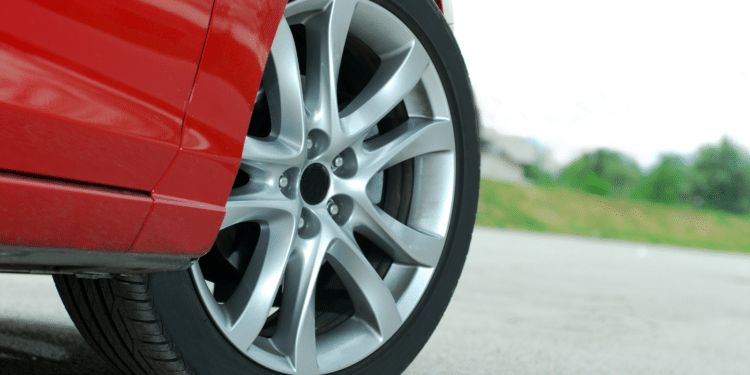 Closeup of a car tire on a red vehicle