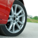 Closeup of a car tire on a red vehicle