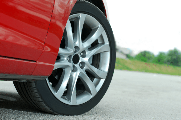 Closeup of a car tire on a red vehicle