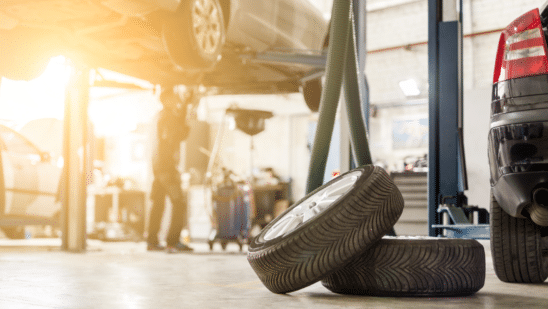 car service center, car raised up, tires in front