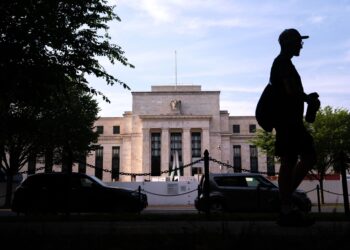 A pedestrian passes the Marriner S. Eccles Federal Reserve building in Washington, DC
