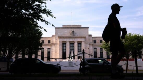 A pedestrian passes the Marriner S. Eccles Federal Reserve building in Washington, DC