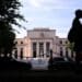 A pedestrian passes the Marriner S. Eccles Federal Reserve building in Washington, DC