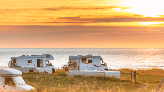 RVs on the water at sunset