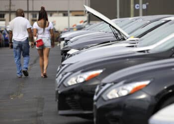 Customers shop for used vehicles at a dealership in Louisville, Kentucky.