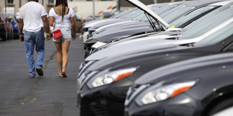 Customers shop for used vehicles at a dealership in Louisville, Kentucky.