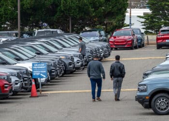 Customers view used Ford vehicles at a dealership in Colma, California, US, on Friday, June 21, 2024. CDK Global, a software provider to some 15,000 car dealers, was waylaid by debilitating cyberattacks this week that have had a crippling effect on the auto sales industry. Photographer: David Paul Morris/Bloomberg