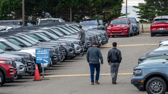 Customers view used Ford vehicles at a dealership in Colma, California, US, on Friday, June 21, 2024. CDK Global, a software provider to some 15,000 car dealers, was waylaid by debilitating cyberattacks this week that have had a crippling effect on the auto sales industry. Photographer: David Paul Morris/Bloomberg