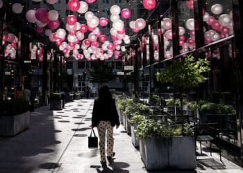 A pedestrian walks past storefronts at CityCenterDC in Washington, DC, US, on Thursday, May 30, 2024. The Bureau of Economic Analysis is scheduled to release personal consumption figures on May 31. Photographer: Bloomberg/Bloomberg