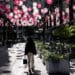 A pedestrian walks past storefronts at CityCenterDC in Washington, DC, US, on Thursday, May 30, 2024. The Bureau of Economic Analysis is scheduled to release personal consumption figures on May 31. Photographer: Bloomberg/Bloomberg