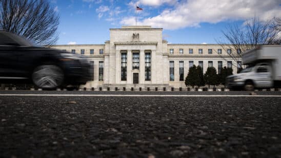 Vehicles pass in front of the Marriner S. Eccles Federal Reserve building in Washington, DC.