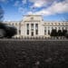 Vehicles pass in front of the Marriner S. Eccles Federal Reserve building in Washington, DC.