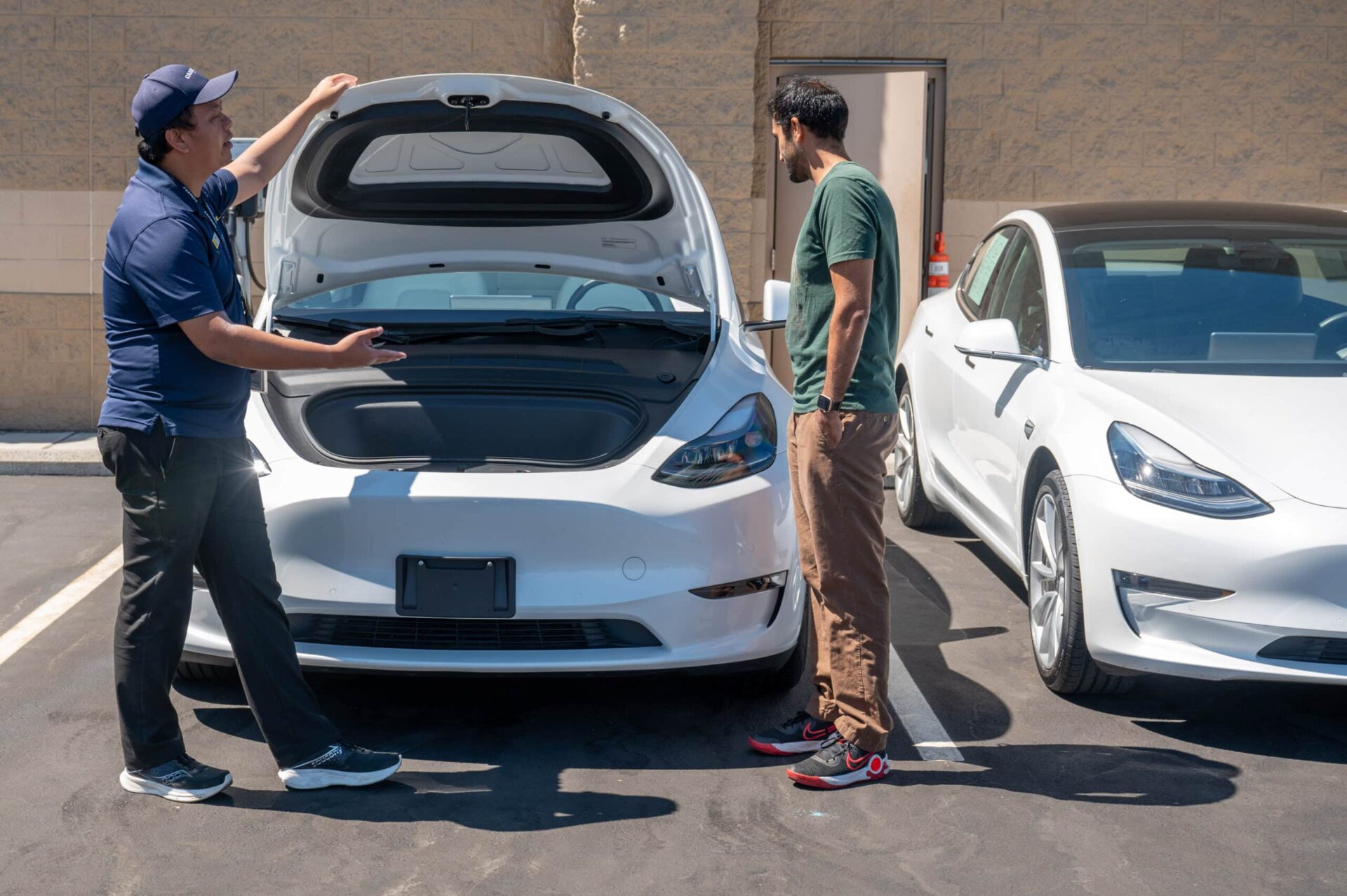A CarMax salesman showing a used Tesla Model Y to a customer in Fremont. Photographer: Amy Osborne/Bloomberg