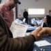 Attendees shake hands at an Employment and Resource Fair in Long Beach, California. Photographer: Eric Thayer/Bloomberg