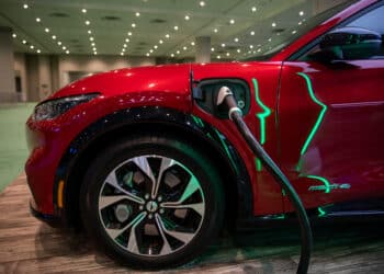 A Ford Mustang Mach-E4 is plugged into a charger during the 2022 New York International Auto Show (NYIAS) in New York, U.S., on Thursday, April 14, 2022. The NYIAS returns after being cancelled for two years due to the Covid-19 pandemic. Photographer: Michael Nagle/Bloomberg