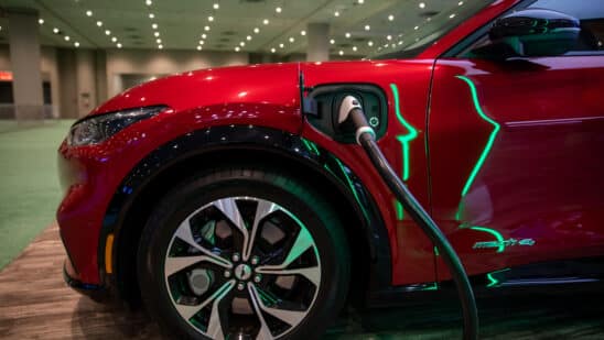 A Ford Mustang Mach-E4 is plugged into a charger during the 2022 New York International Auto Show (NYIAS) in New York, U.S., on Thursday, April 14, 2022. The NYIAS returns after being cancelled for two years due to the Covid-19 pandemic. Photographer: Michael Nagle/Bloomberg
