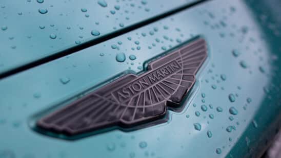 The front badge on an Aston Martin DBX sport utility vehicle (SUV) at the Aston Martin Lagonda Global Holdings Plc factory in St Athan, UK, on Thursday, March 23, 2023. Aston surged after the loss-making manufacturer said itll boost deliveries of lucrative models like the £190,000 ($229,349) DBX707 sport utility vehicle. Photographer: Chris Ratcliffe/Bloomberg