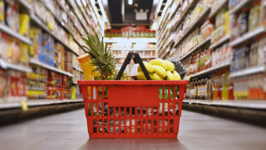 close up of groceries in basket on aisle