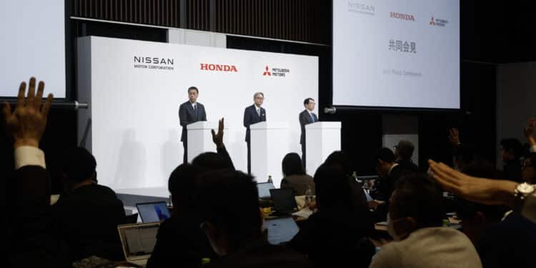 Nissan CEO Makoto Uchida, from left, Honda CEO Toshihiro Mibe and Mitsubishi CEO Takao Kato attend a news conference on Dec. 23. Photographer: Kiyoshi Ota/Bloomberg