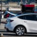 A customer looks at the trunk of a vehicle at a Tesla store in Colma, California. Photographer: David Paul Morris/Bloomberg