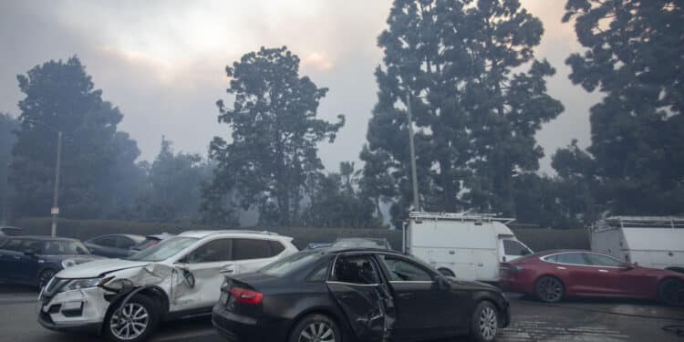 Damaged cars after being bulldozed out of the way to provide access for firefighters during the Palisades Fire in the Pacific Palisades neighborhood of Los Angeles, California, US, on Tuesday, Jan. 7, 2025. A fast-moving wildfire ripped through an affluent neighborhood in Los Angeles, forcing thousands of people to evacuate as the region braced for a brutal wind storm that could last well into the weekend. Photographer: Jill Connelly/Bloomberg