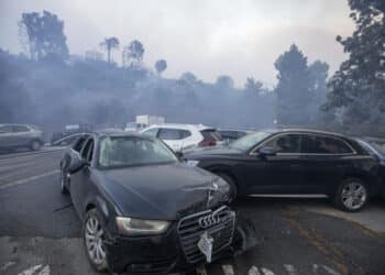 Damaged cars after being bulldozed out of the way to provide access for firefighters. (Photo/Bloomberg)