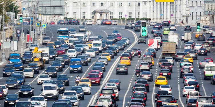Lanes of a wide city street with lots of cars