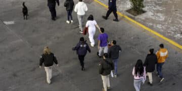 Mexican immigration officials and police escort deportees in Nogales, Arizona, on Jan. 22.