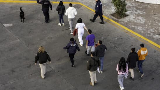 Mexican immigration officials and police escort deportees in Nogales, Arizona, on Jan. 22.