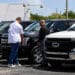 A customer views a new Ford Pro Super Duty pickup truck displayed for sale at a Ford Motor Co. dealership in Miami, Florida, US, on Saturday, April 5, 2025. Car buyers have been rushing to US showrooms to lock in deals before potential price hikes, and automakers are bracing for significant potential cost increases and supply-chain turmoil, with some companies planning to temporarily halt production or reduce overtime.